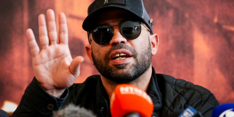 Former national chairman of the Proud Boys Enrique Tarrio talks to the media in Miami