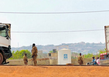 FILE PHOTO: Malian soldiers stand near a truck during a patrol following the attack on Mali's main military base Kati, out...