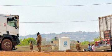 FILE PHOTO: Malian soldiers stand near a truck during a patrol following the attack on Mali's main military base Kati, out...