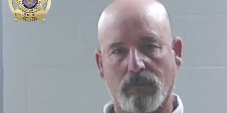Mugshot of a bald goateed man