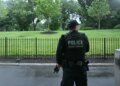 An armed Secret Service agent reacts at the White House