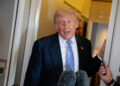 FILE PHOTO: U.S. President Donald Trump speaks to members of the media on board Air Force One, following his visit to China