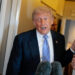 FILE PHOTO: U.S. President Donald Trump speaks to members of the media on board Air Force One, following his visit to China