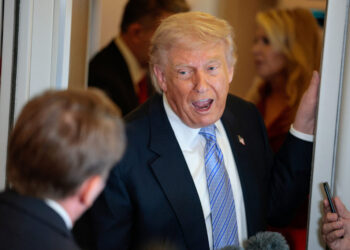 U.S. President Donald Trump speaks to members of the media on board Air Force One, following his visit to China