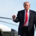 President Donald Trump walking from the Marine One helicopter toward Air Force One at an airport.