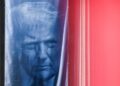 A banner depicting U.S. President Donald Trump hangs outside the Department of Justice building in Washington