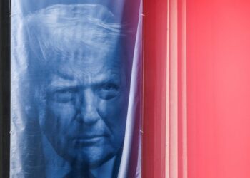 A banner depicting U.S. President Donald Trump hangs outside the Department of Justice building in Washington