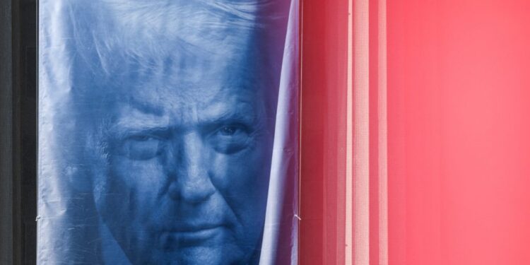 A banner depicting U.S. President Donald Trump hangs outside the Department of Justice building in Washington