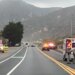 California Highway Patrol officers, an ambulance and emergency vehicles are seen at the scene of a fatal crash involving three bicyclists and a pickup truck on Pacific Coast Highway near Solimar Beach Road in Ventura County, with mountains in the background.