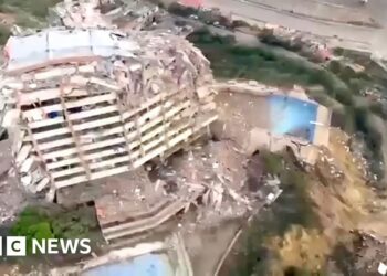 A partly collapsed building from above.