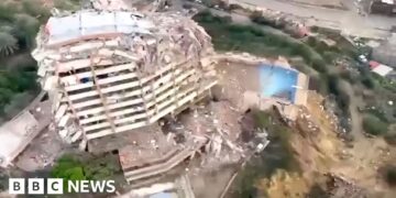A partly collapsed building from above.