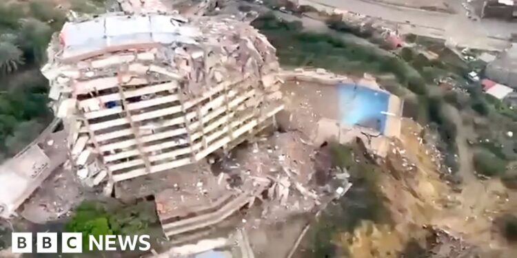 A partly collapsed building from above.