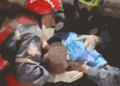 Gif of an infant trapped beneath the rubble being rescued