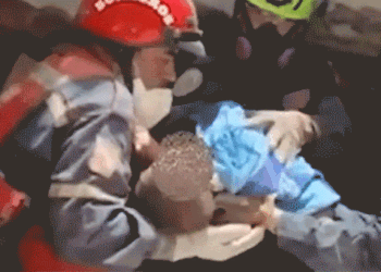 Gif of an infant trapped beneath the rubble being rescued