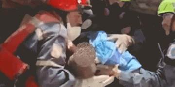 Gif of an infant trapped beneath the rubble being rescued