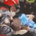 Gif of an infant trapped beneath the rubble being rescued