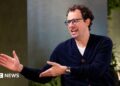 Dario Amodei, co-founder and chief executive officer of Anthropic, speaking during an interview in a room decorated with plants