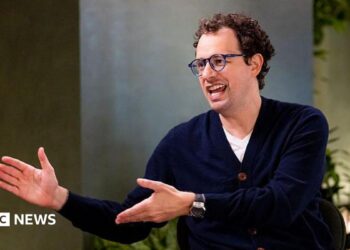 Dario Amodei, co-founder and chief executive officer of Anthropic, speaking during an interview in a room decorated with plants