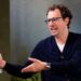 Dario Amodei, co-founder and chief executive officer of Anthropic, speaking during an interview in a room decorated with plants