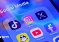 The app symbols for Snapchat, YouTube, Facebook, TikTok, Instagram and X are displayed on a smartphone screen, under the label Social Media.