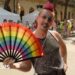 Man holds a pride fan