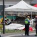 Emergency service workers speak to each other as the attend a light aircraft crash site