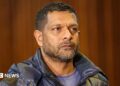 South Africa's deputy head of crime intelligence Feroz Khan is seen in court. He has short hair and a short beard
