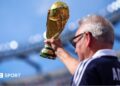 A Scotland supporter raises a replica FIFA World Cup Trophy in the stands prior to during the Group C match against Morocco