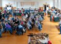 Dozens of people, seated in multiple rows of chairs, gather for a presentation during Talbot County's Native American Heritage and Artifact Day, held in February. Some Native Americans artifacts are seen on the floor, near the small crowd.