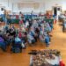 Dozens of people, seated in multiple rows of chairs, gather for a presentation during Talbot County's Native American Heritage and Artifact Day, held in February. Some Native Americans artifacts are seen on the floor, near the small crowd.