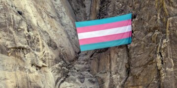 A group of transgender queer allied climbers unfurl a trans pride flag on El Capitan in Yosemite National Park