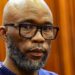 A head and shoulders picture of Cat Matlala in court - he is wearing a blue jumper, the neckline of which can just be seen at the bottom of the picture.