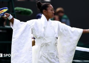 Naomi Osaka wears an all-white kimono as she prepares to warm-up before her first-round match at Wimbledon