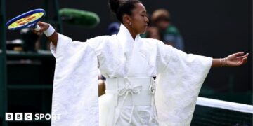 Naomi Osaka wears an all-white kimono as she prepares to warm-up before her first-round match at Wimbledon