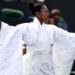 Naomi Osaka wears an all-white kimono as she prepares to warm-up before her first-round match at Wimbledon