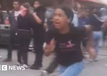 A girl runs from building damagd by earthquake in  El Junquito near Caracas
