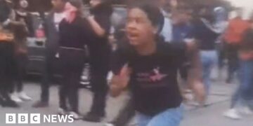 A girl runs from building damagd by earthquake in  El Junquito near Caracas