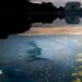 Chipped paint and algae are visible in the Lincoln Memorial Reflecting Pool at dusk.