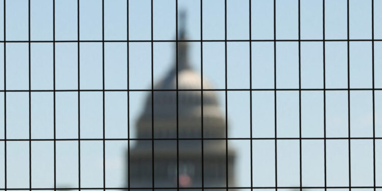 Dome of the U.S. Capitol seen through construction fencing as preparations for Freedom 250 continue along the National Mal...