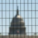 Dome of the U.S. Capitol seen through construction fencing as preparations for Freedom 250 continue along the National Mal...