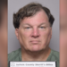 Rex Heuermann has wavy borwn hair in his latest mugshot, wearing a green shirt and holding placard that reads Suffolk County Sheriff's Office