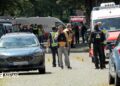 Crowds of emergency workers stand in the road following a shooting in Stade, northern Germany.