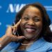 Lisa D. Cook, a member of the Board of Governors of the Federal Reserve, smiles while holding her hand against her face. She is wearing a blue suit and speaks at The Capital Hilton during the 42nd annual National Association for Business Economics Economic Policy Conference on February 24, 2026 in Washington, DC.