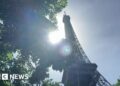 The Sun shining behind the Eiffel Tower
