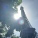 The Sun shining behind the Eiffel Tower