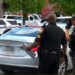 Police officers standing near vehicles at a crime scene in Toledo, Ohio
