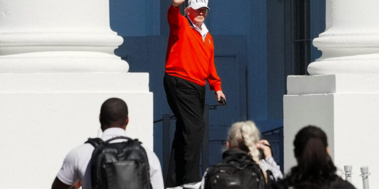 U.S. President Donald Trump waves as he returns to the White House, in Washington