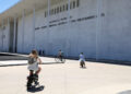 Cyclists ride by the Kennedy Center in Washington