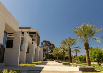 Student walking on a walkway at University of California Santa Barbara campus
