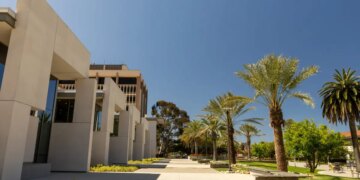 Student walking on a walkway at University of California Santa Barbara campus